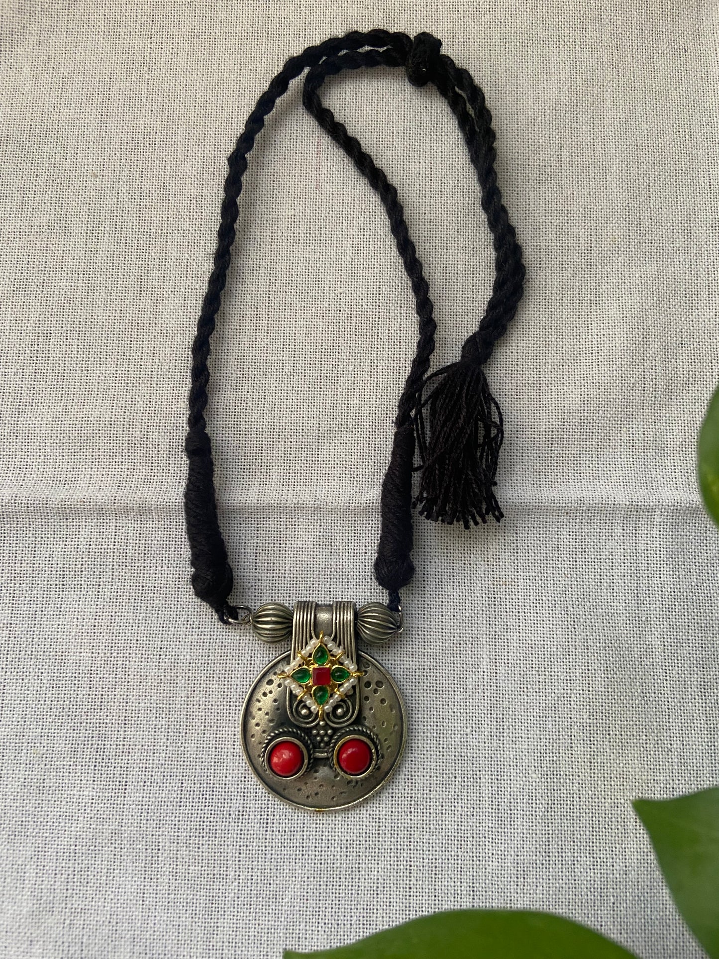 Traditional dual tone pendant with black thread