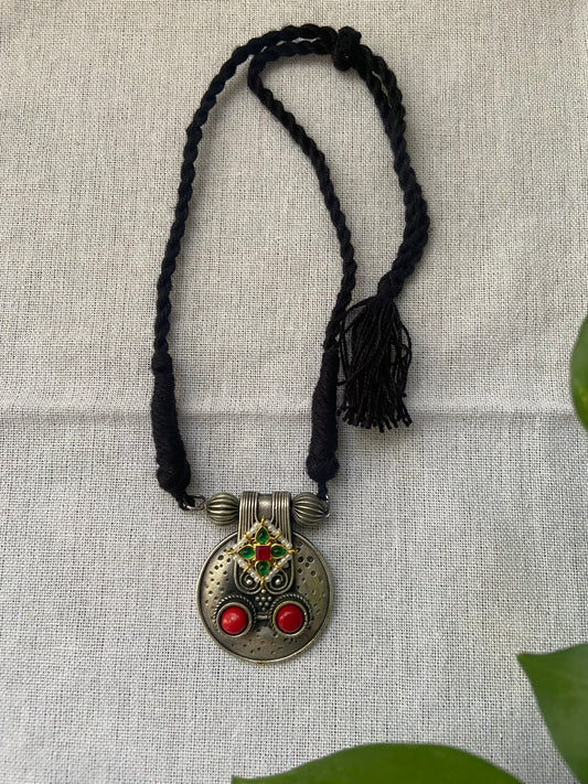 Traditional dual tone pendant with black thread
