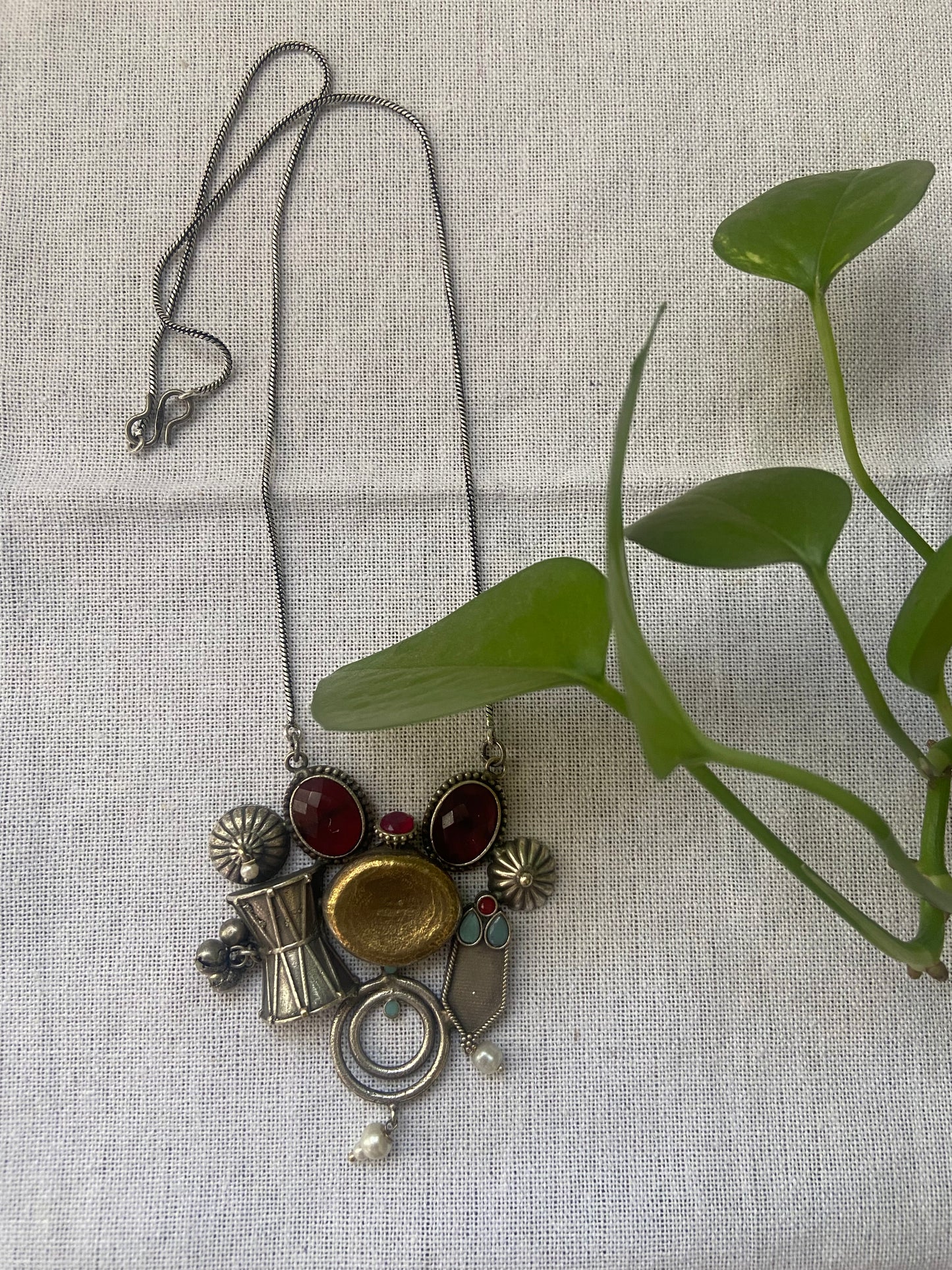 Dual tone pendant with long brass chain